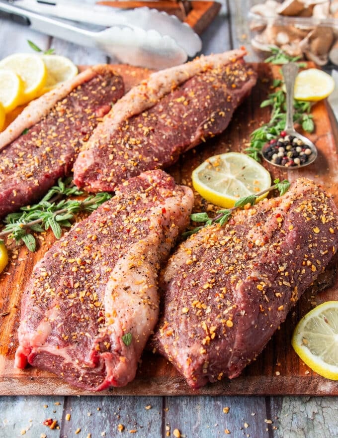 Picanha steaks seasoned on both sides with coarse salt, pepper and some steak seasoning 
