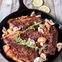 Mushrooms and whole garlic cloves, butter and herbs are aded to the picanha steaks