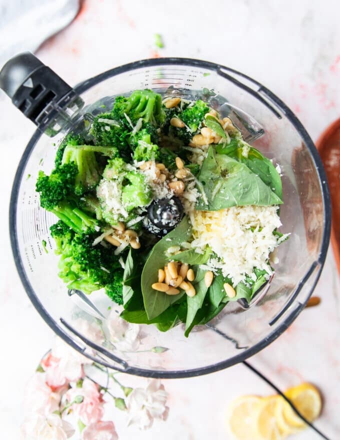 Broccoli pesto ingredients all added into a food processor bowl