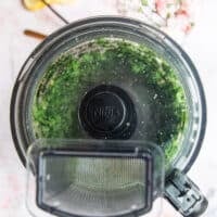 basil pesto being pureed in a food processor