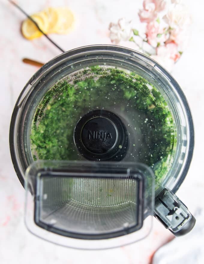 basil pesto being pureed in a food processor