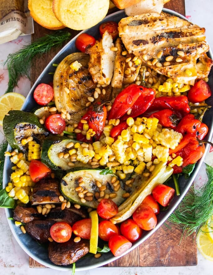 A full plate of grilled chicken salad dressed with lemon dressing