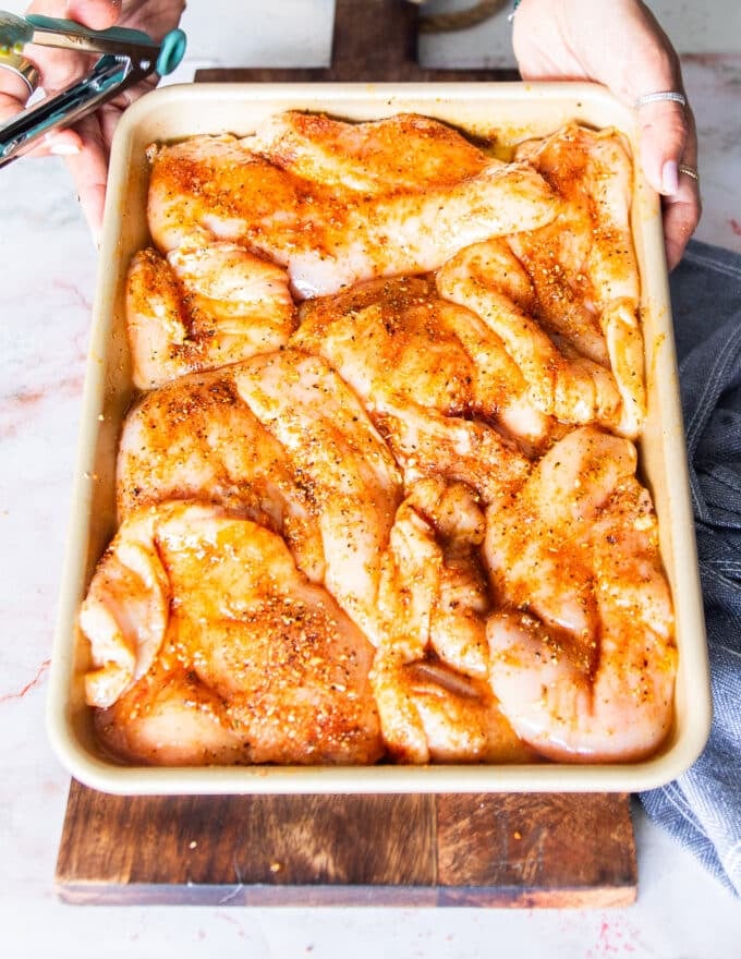 Chicken pieces are now coated in the spice blend and olive oil