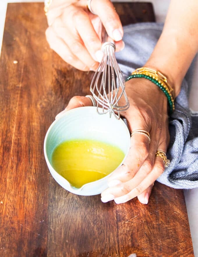 Make the salad dressing by whisking all ingredients in a small bowl