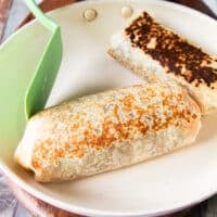 burrito crisping in a hot skillet