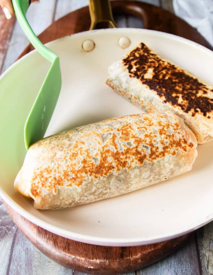 burrito crisping in a hot skillet