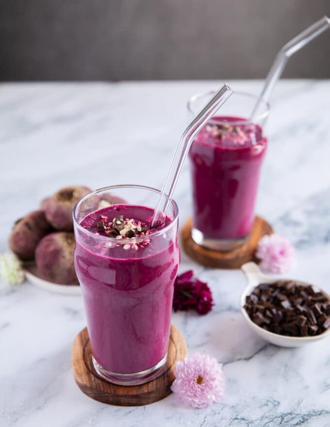 two cups of sweet beet smoothies garnished with chocolate chips