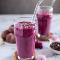 close up of a cup of beet smoothie showing the smooth texture and gorgeous color