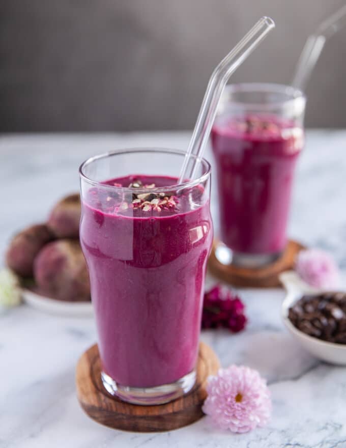 close up of a cup of beet smoothie showing the smooth texture and gorgeous color
