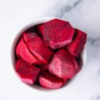 fresh beets are peeled and chopped in a bowl ready to use in our beet smoothie