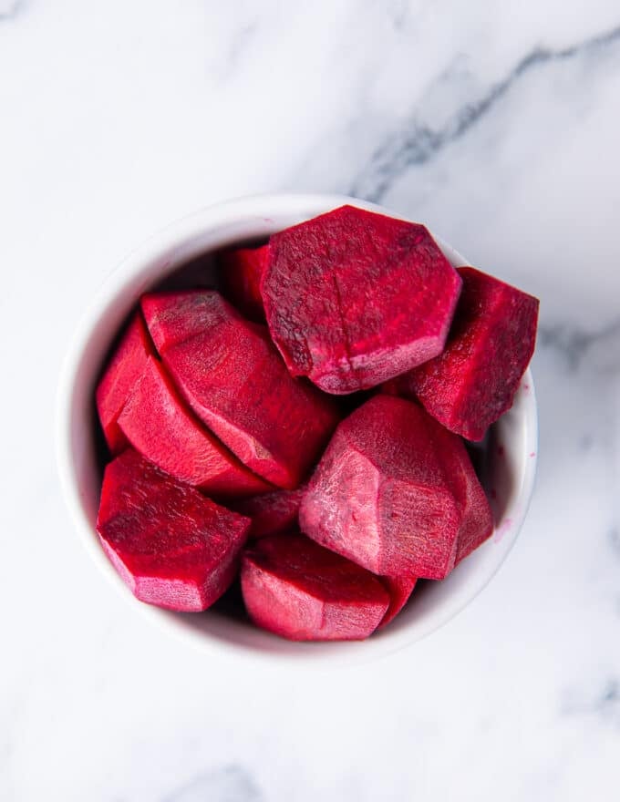 fresh beets are peeled and chopped in a bowl ready to use in our beet smoothie